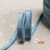 En stock 48 colores poliéster velcro con borde de cordón ribeteado tira de inserción de cuerda para ropa colchas sofás cojines tira de ribete