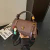 Bolsa de nicho minimalista de moda transfronteiriça, bolsa transversal nova vintage outono 2026, versão coreana bolsa quadrada pequena de mão simples