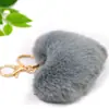 Venta caliente llavero de felpa de amor llavero de bola de pelo de corazón de melocotón colgante accesorios para equipaje de dama coche al por mayor