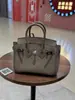 Bolso de alta calidad 2026 comercio exterior transfronterizo nuevo modelo piel de becerro togo platino, piel genuina, moderno y versátil, bolso de mano con colores contrastantes