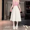 Saia midi preta em linha A para corpo em forma de pera feminina primavera petite comprimento médio cintura alta modeladora temperamento saia estilo coreano