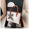 Bolsa de Mão Quadrada Pequena Color Block com Estampa de Cobra Fashion Atacado para Mulheres, Novo Estilo Primavera 2026, Bolsa de Ombro Único Transversal com Laço de Lenço de Seda