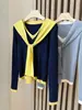 Conjunto de dos piezas real V-neck suéter de punto de manga larga para mujer, otoño e invierno 2026, diseño versátil con colores contrastantes y top tipo chal