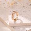Europa y Estados Unidos venta caliente transfronteriza joyería moda viento simple micro incrustación forma de nudo abierto anillo de circón dorado para mujer