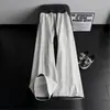 Pantalones de chándal de cuadros patchwork deconstruidos negros para hombre, marca de tendencia de otoño, pantalones rectos de alta gama que estilizan, pantalones de microcampana estilo americano