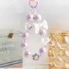 Colgante de flor pequeña de colores electrochapados para funda de teléfono, llavero, accesorios para bolso, colgante de cadena de cuentas de lazo