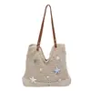Bolsa de mano tipo tote personalizada al por mayor estilo vacacional para mujer 2026 Verano Nuevo Bolso de hombro tejido calado Bolso de axila moderno
