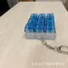 Llavero Yingfei con forma de probador de nueve teclas, colgante pequeño de acrílico con diseño de dibujos animados, ideal para fiestas de graduación o cumpleaños.