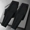 Calças masculinas para primavera e outono, calças casuais da moda com bolsos com zíper, calças esportivas jogger retas largas