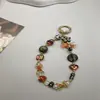 Sino de Vento Exótico Orquídea Corrente de Celular Ins Moda de Alto Padrão Pingente de Pulso Feminino Capa de Celular Corrente Pendente de Contas