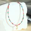 Collar de cuentas de arroz de piedra natural de alta calidad con nuevo color de nicho transfronterizo, cadena de clavícula con letras de acero de titanio y temperamento femenino, venta al por mayor
