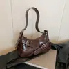 Bolsa de Ombro Fashion e Sofisticada para Mulheres Verão 2025 Versão Coreana Tendência Versátil Bolsa para Motociclista Simples de Nicho para Mulheres