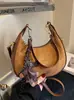 Bolso de axila tipo 'dumpling' de nicho francés de alta gama transfronterizo para mujer, nuevo bolso de mano de moda, bolso de hombro versátil de estilo extranjero