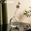 Botella de aceite esencial redonda plana de 60 ml en stock del fabricante, botella de vidrio para sérum