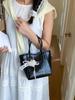 Bolso de Mano Pequeño de Nicho de Verano Transfronterizo para Mujer Nuevo Modelo 2026 Bolso Cubo Sencillo de Color Sólido Bolso Versátil de Hombro Cruzado
