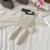 Calcetines de estilo dulce y preppy hasta la mitad de la pantorrilla para mujer, otoño e invierno, con elaborados accesorios de lazo y estampados de lunares, calcetines largos de algodón con un dobladillo fruncido