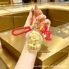 Oro puro 999 "Youqianhua" cadena para teléfono móvil de oro llavero colgante para bolso caja de regalo regalo pequeño promocional personalización cultural y creativa