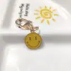 Llavero de cara sonriente de color aleación con goteo transfronterizo de comercio electrónico, accesorios de colgante para bolso con expresión irregular chapado en oro