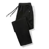 Calça casual masculina 2024 outono e inverno nova forrada com fleece espessa estilo coreano bolso na ponta do pé zíper calça plus size geração