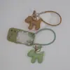 Funda para teléfono con borla de cachorro linda creativa, correa para llavero de coche, accesorio para bolso, universal para teléfonos móviles