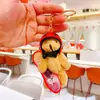Novo Pingente de Pelúcia Urso de Skate Criativo Desenho Animado Fofo Chaveiro Estilo Vento Chaveiro para Mochila de Estudante