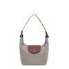 Bolsa de nailon tipo dumpling para mujer, nuevo bolso de mano versátil ligero y simple 2026, bolso de hombro de alta gama con bloques de color para el día a día