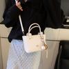 Bolso pequeño de alta gama para mujer, novedad de 2025, bolso bandolera informal combinable, bolso de cubo portátil para ir al trabajo al estilo coreano.