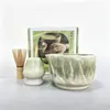 Tazón de té de cerámica texturizado de col blanca tridimensional con pico, emparejado con un soporte para batidor de té del mismo color, múltiples accesorios para la preparación de matcha