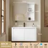 Tocador de baño engrosado y ahorrador de espacio con diseño en color crema, que cuenta con un lavabo redondeado, lavabo cerámico integrado y un lavabo de una sola pieza.