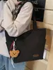 A Bolsa Sacola Casual e Simples Popular Deste Ano para Sala de Aula de Estudantes é uma Bolsa de Ombro Leve da Moda de Grande Capacidade Estilo Executivo para Mulheres