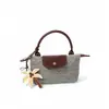 Mini bolso de mano tejido con paja transfronterizo tipo dumpling, bolso de mano retro con tapa abatible, nuevo estilo 2026 bolso tejido para mujer, personalizable para vacaciones