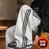 Coleção outono e inverno: calça de moletom casual larga de peso pesado com três listras para homens e adolescentes, corte solto, forrada com fleece, estilo perna reta, moderna