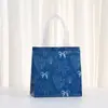 Nuevo producto de comercio exterior: bolsa de regalo azul océano de verano con lazo, bolsa de tela no tejida con impresión laminada, bolso de mano