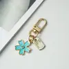 Chaveiro de Metal Flor de Cinco Folhas Coreano Ins Pen Drive de Nicho Capa Protetora para Fone de Ouvido Bluetooth AirPods Pingente
