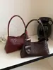 Bolso de mano de nicho de moda estilo francés, nuevo modelo 2026, diseño tejido elegante y simple, sensación de alta gama, bolso de hombro único para debajo del brazo