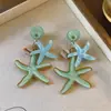 Pendientes de resina con forma de estrella de mar y concha de aguja plateada, pendientes exquisitos estilo resort costero, pendientes de diseño nicho para mujer con un toque de alta gama