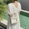 Bolsa de Mão Pequena de Início de Primavera Transfronteiriça para Mulheres 2026 Novo Estilo Bolsa Quadrada Pequena para o Trabalho/Trajeto Bolsa de Ombro Único Transversal Estilosa e Elegante