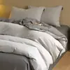 Juego de cuatro piezas de algodón puro cepillado de lujo ligero para otoño e invierno, juego de ropa de cama de tres piezas de color liso bicolor de algodón cálido y grueso