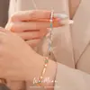 Pulsera con cierre de estrella de circonita chapada en oro real de 18k, sensación de lujo ligero de nicho de alta gama, accesorio de mano versátil y elegante
