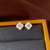 Pendientes de borla con flor de trébol de circonita vintage con un toque de alta gama, pendientes versátiles y de moda al por mayor