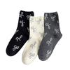 Calcetines de mujer en un pequeño montón, calcetines de seda brillante para niñas, calcetines de tubo estilo coreano con lazo estilo japonés fragante.
