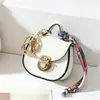 Nuevo accesorio de bolso de moda famoso en internet, charm de mini bolso de sillín, llavero de coche, bolso para labiales, monedero multifuncional, bolsa para auriculares