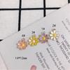 Accesorios al por mayor para joyería DIY nuevos aretes de margarita colgantes de aleación con gota de aceite de personalidad simple material