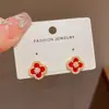Pendientes de botón de flor de cuatro hojas de circonio de moda versátiles estilo francés, exquisitos, sencillos, dulces, compactos y adecuados para ir al trabajo, con sentido del diseño