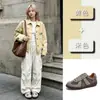 Zapatos de entrenamiento vintage alemanes de cuero de vaca de capa superior para mujer, nuevos zapatos deportivos planos para exteriores de otoño 2026, zapatos versátiles casuales Forrest Gump