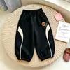 Pantalones deportivos infantiles de estilo europeo y americano, versión coreana, diseño color block, pantalones deportivos casuales para primavera y otoño, con puños elásticos