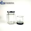 Venta al por mayor de fábrica botella hexagonal transparente de vidrio para miel multi-especificación botella vacía de miel y mermelada frasco hexagonal para alimentos Botella para pepinillos