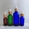 Botella de vidrio esmerilado color té para aceite esencial, tapa de madera de bambú, botella con gotero, submuestra de cosméticos, botella de vidrio, botella para dilución de aceite esencial, venta al por mayor