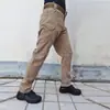Calças táticas masculinas de fábrica direta transfronteiriça para primavera e outono, calças camufladas, macacão resistente ao ar livre, calças de treinamento IX7 com vários bolsos