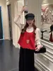 Moda de otoño nueva para mujer chaleco de punto camisa de capas superior falda con dobladillo de terciopelo con volantes conjunto de tres piezas
